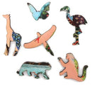 A colorful jigsaw puzzle titled 'Pride of Peacocks' by Marie Amalia, featuring intricately designed puzzle pieces shaped like various animals including a giraffe, butterfly, flamingo, and monkey, showcasing vibrant patterns and colors.