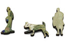 Three unique wooden puzzle pieces from the 'Poets by a Winding Stream' jigsaw puzzle by Artifact Wooden Puzzles. The pieces feature intricate designs, including a figure of a person, a playful dog, and another figure, all showcasing vibrant colors and artistic details. Ideal for puzzle enthusiasts and art lovers alike.