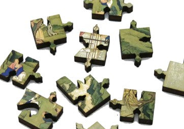 A collection of intricately shaped wooden jigsaw puzzle pieces featuring scenes of nature and serene figures. The pieces showcase detailed artwork, including lush greens and soft colors, suggesting a tranquil landscape. Each piece has unique designs and a smooth finish, ideal for puzzle enthusiasts and collectors.