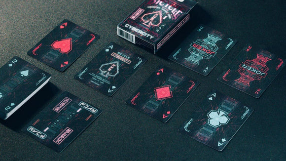 A vibrant set of Bicycle Cyberpunk Cybercity playing cards spread out on a dark surface. The cards feature futuristic designs with neon colors, including Ace cards and Jokers, all packaged in an eye-catching box that showcases the Cybercity theme.