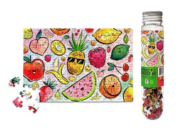 A colorful jigsaw puzzle featuring a whimsical fruit design, including strawberries, watermelons, and pineapples. The puzzle is displayed alongside its packaging in a clear, cylindrical container, with several puzzle pieces scattered nearby.