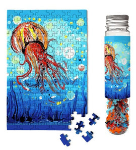 Bubbly Jellyfish jigsaw puzzle by Micro Puzzle displayed with completed puzzle artwork featuring a vibrant jellyfish against a blue background. The accompanying container holds puzzle pieces, showcasing the creative design.