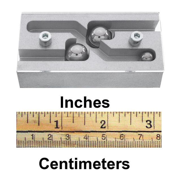 R2D2 Puzzle by Jean-Claude Constantin, featuring a mechanical design with three metallic balls positioned within a flowing maze structure. The product is displayed alongside a ruler indicating inches and centimeters for size reference.
