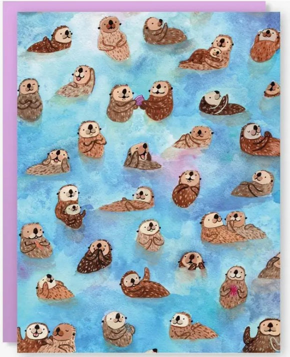 A whimsical greeting card featuring a vibrant underwater scene filled with playful otters in various poses. The background is a soothing gradient of blue, while the otters are illustrated in warm brown tones, engaging with one another. This card is designed by Cactus Club Paper Goods and includes a soft purple border, making it a delightful choice for any occasion.