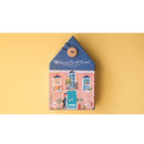 Welcome to My Home reversible jigsaw puzzle by Londji, featuring colorful illustrations of a house with playful characters and pets. Packaged in a house-shaped box with a button clasp, designed for engaging and imaginative play. Contains 36 pieces suitable for various skill levels.