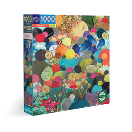 Eeboo's Pebbles jigsaw puzzle featuring a vibrant array of colorful pebbles, seashells, and underwater plants. The puzzle contains 1000 pieces and is packaged in a sturdy box made from recycled materials, emphasizing eco-friendliness.