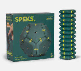 A green packaging of the SPEKS Geode: Monstera, featuring a magnetic fidget sphere. The box showcases its unique design with yellow accents, and next to it, several stacked green magnetic pieces are displayed. The product is designed for fidgeting and offers a fun, interactive experience.