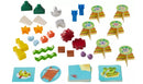A colorful collection of game pieces for the Flotsam Float game by Haba. The set includes various shaped tokens in vibrant colors and images depicting beach themes. Each piece is designed to enhance creative play and teamwork, making it an engaging activity for children.