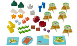 A colorful collection of game pieces for the Flotsam Float game by Haba. The set includes various shaped tokens in vibrant colors and images depicting beach themes. Each piece is designed to enhance creative play and teamwork, making it an engaging activity for children.