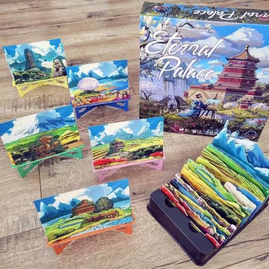 Eternal Palace board game by Alley Cat Games featuring beautifully illustrated cards and a colorful game board. The box showcases vibrant scenery with various landscapes, adding an artistic touch to game night. Perfect for family and friends.