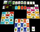 The game 'Verdant' by Alderac Entertainment Group, featuring colorful cards and game pieces laid out on a black surface. The game includes various plant-themed cards, pots, and tokens, promoting strategic gameplay focused on gardening and plant collection.