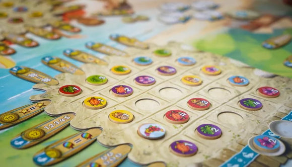 Close-up of the board game 'Fyfe' by Burnt Island Games, featuring colorful tokens and a vibrant game board with a beach and tropical theme. The board displays various icons and numbers, inviting players to engage in dynamic gameplay.