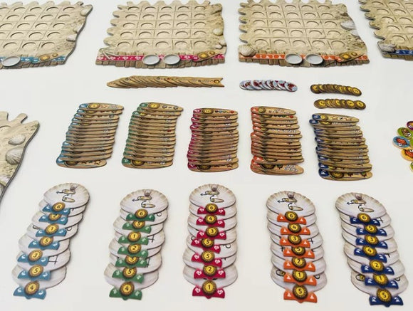 The game 'Fyfe' by Burnt Island Games features a collection of colorful tokens and boards. The layout includes three game boards with circular slots, several stacks of tokens in various colors, and multiple player boards, each showcasing numbered icons and unique designs. This strategic game emphasizes planning and resource management.