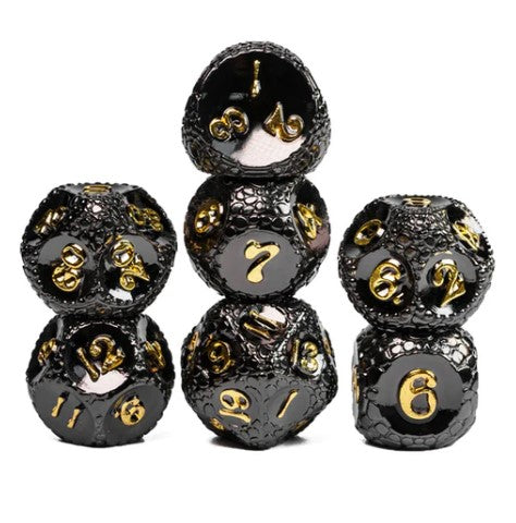 Set of five metal RPG dice with a dragonstone texture, featuring a shiny black finish and golden numbers. The dice are arranged in a stack, showcasing various sides and designs, perfect for tabletop gaming enthusiasts.