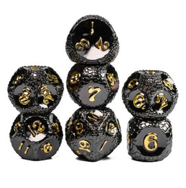 Set of five metal RPG dice with a dragonstone texture, featuring a shiny black finish and golden numbers. The dice are arranged in a stack, showcasing various sides and designs, perfect for tabletop gaming enthusiasts.
