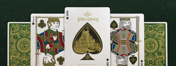 Lord of the Rings Card Deck by Theory 11 featuring detailed illustrations of iconic characters and elements from the series. The deck includes intricately designed face cards, showcasing characters like Frodo and Aragorn, set against a rich green background with distinct symbols from Middle-earth. Perfect for fans and collectors alike.