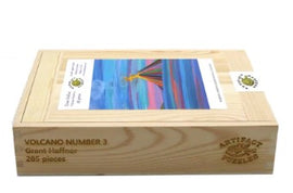 The packaging of Volcano#3 jigsaw puzzle by Grant Haffner from Artifact Wooden Puzzles. The box features a vibrant artwork depicting a volcano surrounded by colorful skies. It contains 285 pieces and is made from high-quality wood, designed for puzzle enthusiasts.