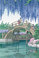 A beautifully illustrated jigsaw puzzle titled 'The Wisteria In Kameido' by Wilson Jeux. The image features a serene scene of a wooden bridge adorned with wisteria, surrounded by lush greenery and colorful flowers, capturing a tranquil moment by the water.