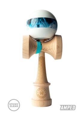 The Bryson Lee Kendama by Sweets Kendamas features a beautifully crafted wooden base with intricate designs and a vibrant white and teal ball. The kendama has a smooth finish and a colorful band for enhanced grip, making it perfect for tricks and skill development.