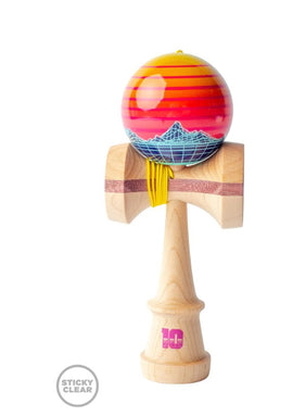 C. Fraser Synthwave Kendama by Sweets Kendamas features a vibrant ball with a sunset gradient and a geometric mountain design, mounted on a sturdy wooden handle with a unique grip. Perfect for skill-based fun and creative tricks.