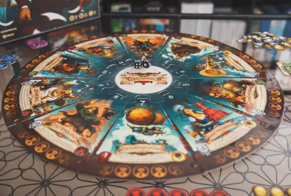 A vibrant board game titled 'Orconomics' from ARES GAMES. The circular game board features intricate illustrations and colorful tokens for player interaction. In the center, a pair of dice sits ready for gameplay. The outer rim showcases character cards and symbols associated with various game mechanics, perfect for strategy and fun.
