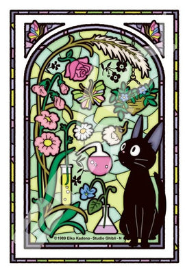 A colorful stained glass illustration featuring Jiji, the black cat from Kiki's Delivery Service, surrounded by various flowers and potion flasks in a sunlit room. The vibrant colors and intricate details capture the whimsical essence of the beloved Studio Ghibli film.
