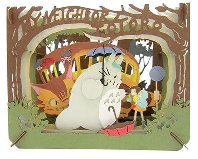 A beautifully crafted Paper Theater DIY kit featuring a charming scene from My Neighbor Totoro. The intricate design showcases Totoro holding an umbrella, surrounded by lush greenery, with the Catbus and other characters in the background, perfect for fans of the anime.