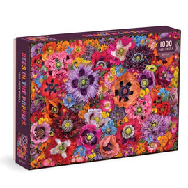 Bees in the Poppies jigsaw puzzle by Galison featuring a vibrant collage of colorful flowers. The puzzle consists of 1000 pieces, showcasing a variety of blossoms in shades of pink, purple, and orange, creating a lively and cheerful design.