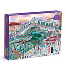 The Michael Storrings Venice jigsaw puzzle by Galison features a vibrant illustration of Venice's iconic landscape. It depicts the famous Rialto Bridge bustling with tourists, gondolas gliding through the canals, and lively market scenes, all illustrated in bright colors. The puzzle consists of 1500 pieces and comes in an eye-catching box that showcases the artwork.