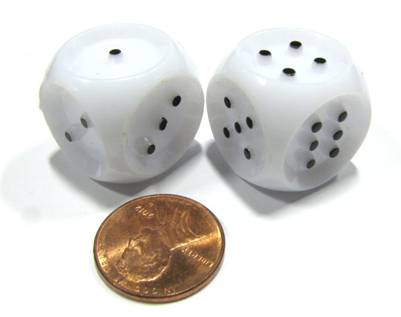 Close-up of a pair of 20mm tactile dice, designed by Koplow Games. The dice are white with black dots and are displayed next to a penny for size comparison.