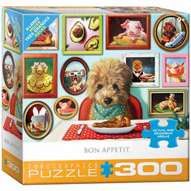 Bon Appetit jigsaw puzzle box featuring a charming illustration of a dog in a green bandana sitting at a table with a plate of chicken. Surrounding the dog are various framed artwork pieces showcasing food and animals, adding a playful touch. The puzzle contains 300 pieces, designed for ages 9 and up, with large-sized pieces for easier handling.