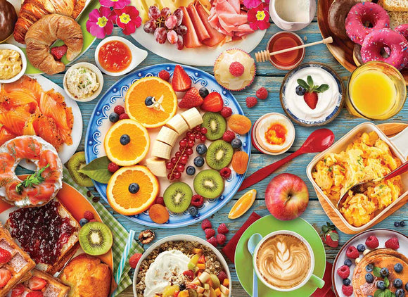 A colorful jigsaw puzzle depicting a breakfast table filled with a variety of delicious foods. The image showcases an array of fruits including oranges, bananas, and berries, along with pastries like croissants and donuts, and dishes like scrambled eggs, yogurt, and granola. The vibrant colors and detailed presentation create an inviting and appetizing scene perfect for breakfast lovers.
