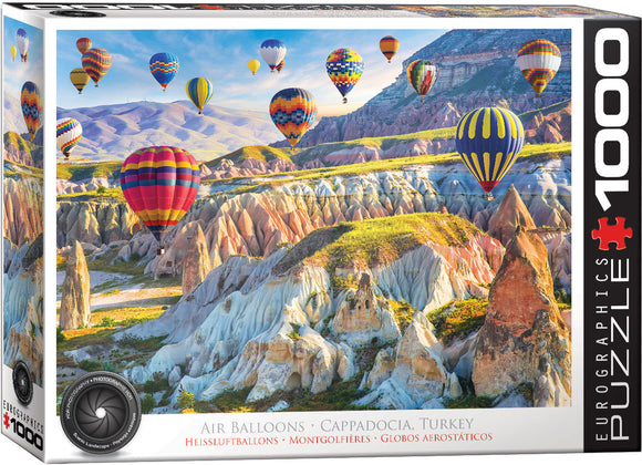 A vibrant jigsaw puzzle featuring breathtaking air balloons floating over the unique rock formations of Cappadocia, Turkey. The puzzle showcases an array of colorful hot air balloons set against a stunning backdrop of hills and valleys, inviting enthusiasts to piece together this picturesque scene. Made by Eurographics, this 1000-piece jigsaw puzzle is perfect for puzzle lovers and travelers alike.
