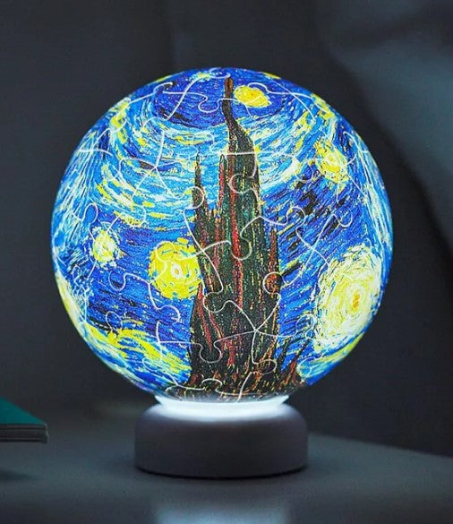 3D jigsaw puzzle light featuring Van Gogh's iconic 'Starry Night' design. The puzzle is illuminated from underneath, showcasing vibrant colors and intricate details. The globe shape adds a whimsical touch, making it a perfect decorative piece for any room.