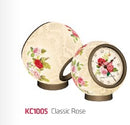 A Classic Rose 3D Jigsaw Puzzle Clock by Pintoo, showcasing an elegant design featuring roses on a textured background. The clock has a round shape, adding a decorative touch to any space. Ideal for puzzle enthusiasts and collectors.