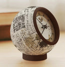 A stylish Manuscript Coffee 3D jigsaw puzzle clock by Pintoo, showcasing an intricate design with coffee-themed illustrations and a classic clock face, elegantly displayed on a wooden surface.