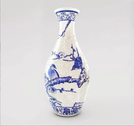 A beautifully designed 3D jigsaw puzzle vase featuring a stunning depiction of magpies perched on branches of a plum tree, adorned with intricate blue patterns on a white background. This unique puzzle offers both a challenging experience and a decorative piece that stands out in any setting.