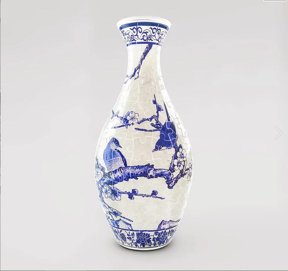 A beautifully designed 3D jigsaw puzzle vase featuring a stunning depiction of magpies perched on branches of a plum tree, adorned with intricate blue patterns on a white background. This unique puzzle offers both a challenging experience and a decorative piece that stands out in any setting.