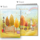 Colorful autumn-themed A5 jigsaw notebook cover featuring a picturesque park scene with a bench, trees in vibrant autumn colors, a bicycle adorned with flowers, and a castle in the background. The back side of the notebook displays a similar serene landscape with a lamp post and autumn leaves falling gently.