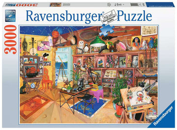 The Curious Collection 3000 piece jigsaw puzzle by Ravensburger, featuring a vibrant and busy room filled with various curiosities, art supplies, and decorative items. The scene includes an ocean view through an open door, showcasing a mix of nautical elements, artistic tools, and whimsical decor, all inviting puzzle enthusiasts to explore and assemble the colorful details.
