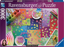Ravensburger Karen Puzzles on Puzzles 3000 jigsaw puzzle featuring a vibrant and colorful assortment of puzzle pieces scattered across a gradient background. Includes bowls with pieces and arts supplies like colored pencils. Ideal for puzzle enthusiasts and families looking to enjoy a relaxing activity.