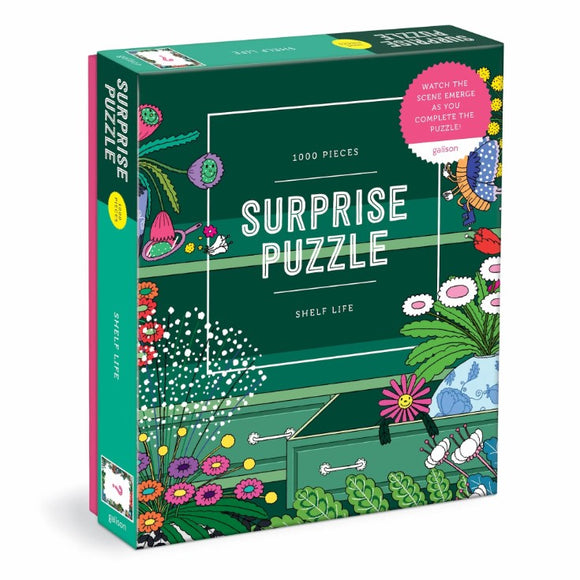 A colorful jigsaw puzzle box titled 'Shelf Life Surprise Puzzle' by Galison, featuring a vibrant design with flowers and gardening themes. The box contains 1000 pieces and has a sticker that says 'Watch the scene emerge as you complete the puzzle!'