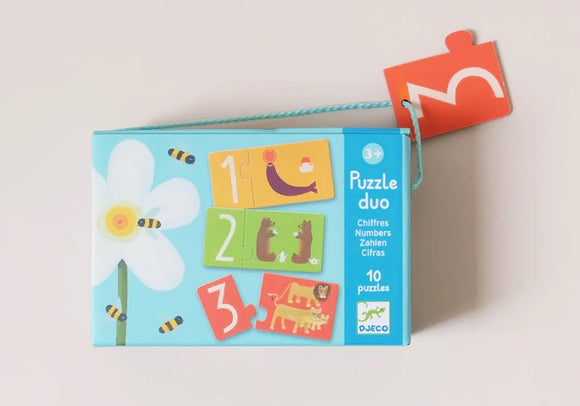 The Numbers Puzzle Duo by DJECO features a colorful jigsaw puzzle box designed for children aged 3 and up. The box showcases puzzles with numbers 1, 2, and 3 alongside playful illustrations of animals. It contains a total of 10 engaging puzzles that promote learning and development.