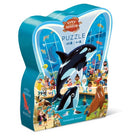 The 'Day at the Aquarium' jigsaw puzzle by Crocodile Creek features a colorful scene depicting various sea animals, including orcas and a walrus, with children and adults enjoying their time at the aquarium. The puzzle comes in a uniquely shaped box, making it an engaging and cute addition for kids aged 4 and up.