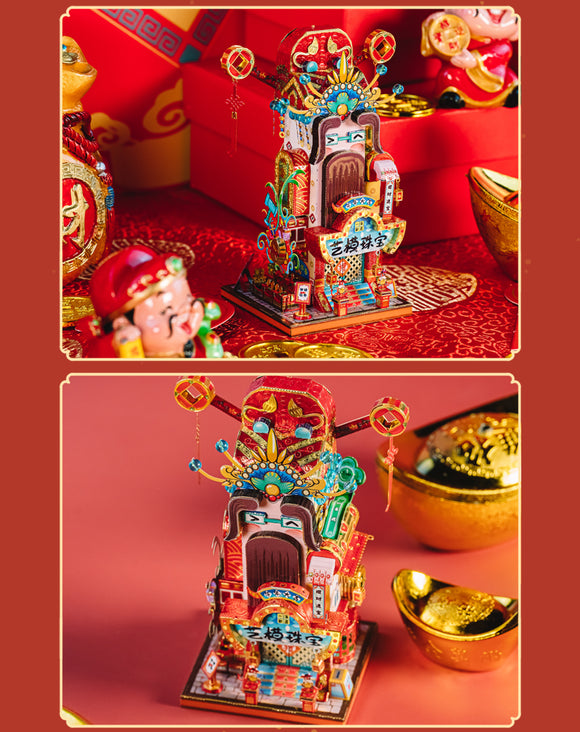 A vibrant DIY kit featuring the Travel the World Jewelry from the God of Wealth, designed by Mu Model. The assembled piece showcases intricate details and colorful decorations resembling traditional Asian architecture with lanterns and ornate designs, set against a backdrop of gold coins and festive décor, ideal for art and craft enthusiasts.