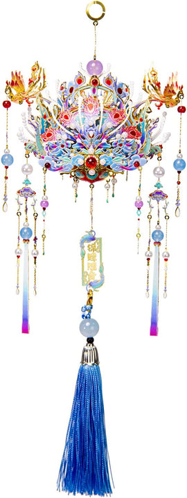 The Phoenix Coronet Yuanchu by Mu Model is a beautifully crafted decorative piece featuring intricate designs and vibrant colors. It showcases a phoenix motif intertwined with flowing ribbons, beads, and a striking blue tassel at the bottom, making it an exquisite addition to any home decor.