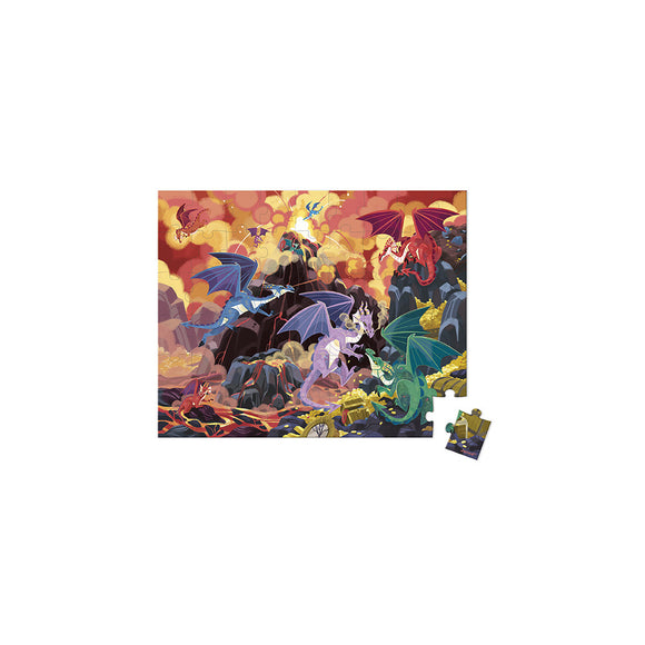 A vibrant jigsaw puzzle titled 'Fiery Dragons' by Janod featuring an epic scene of colorful dragons in a dramatic landscape filled with rocks, treasure, and clouds. The puzzle includes a sample piece displayed on the side, showcasing the intricate artwork and rich colors.