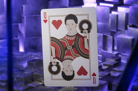 A Queen playing card featuring an illustrated character from Black Panther. The character has an intricate design with a vibrant color scheme, including reds and earth tones, set against a textured background.