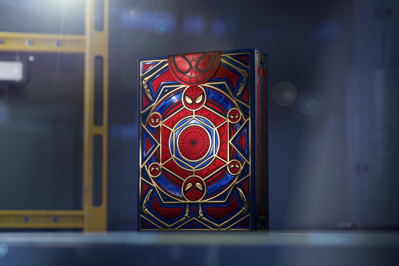 A beautifully designed deck of Spider-Man playing cards by Theory 11, showcasing vivid red and blue colors with intricate gold accents and Spider-Man symbols on the packaging.