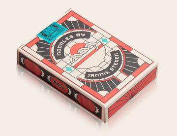 Ramen Heads Playing Cards by Art of Play, featuring a unique design with bold colors and playful noodle graphics. The box showcases modern artwork and is perfect for card enthusiasts and collectors.